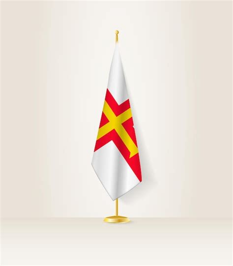 Premium Vector | Guernsey flag on a flag stand