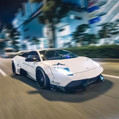 A White Sports Car Driving Down The Street