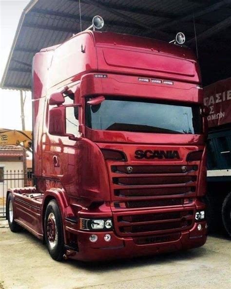 A Red Semi Truck Parked In Front Of A Building