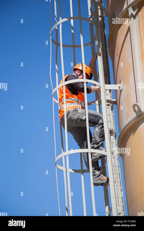 Worker Climbing Smoke Stack Ladder Stock Photo Alamy