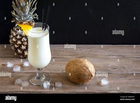 Pina Colada Cocktail With Pineapple And Coconut Over Wooden Background Copy Space Summer