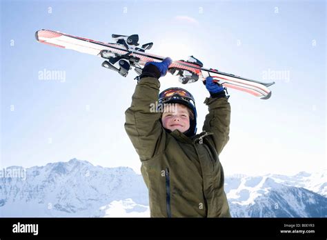 Boy Holding Skis Above His Head Stock Photo Alamy