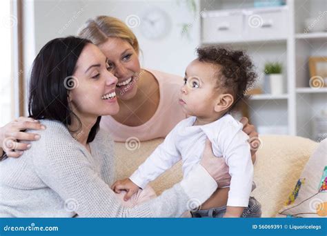 Same Sex Couple Making A Fuss Over Baby Stock Image Image Of Calm Holding