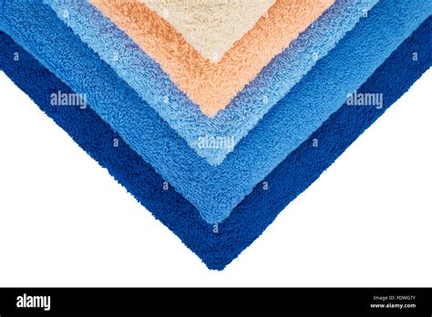 Four colors of terry towels isolated on white Stock Photo - Alamy