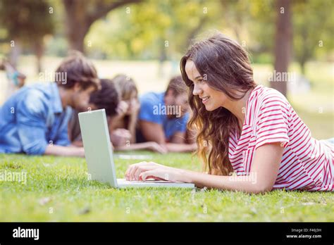 Pretty Brunette Using Laptop In The Park Stock Photo Alamy