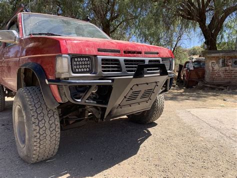 A Red Pick Up Truck Parked In The Dirt