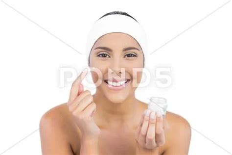 Smiling Nude Brunette Using Moisturizer Looking At Camera Stock Image