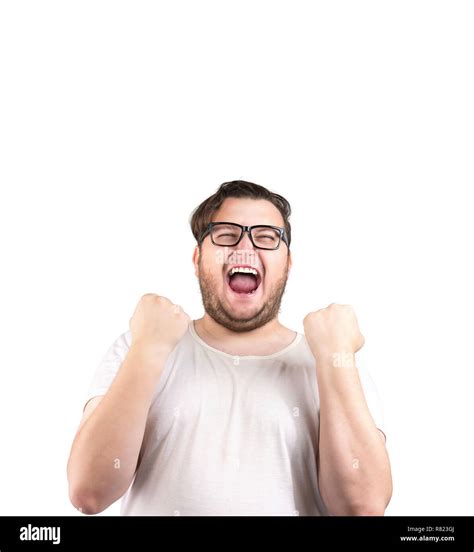 Obese man in glasses holding fists in excitement of victory while ...