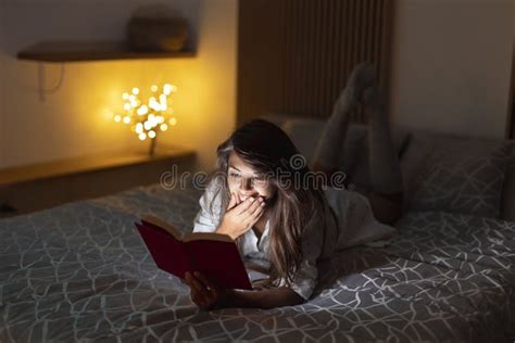 Woman Lying In Bed Reading A Book Stock Image Image Of Screen