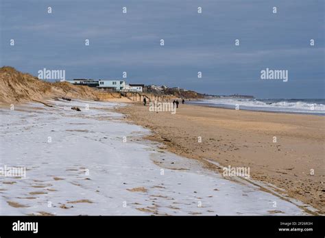 Sand Dunes With A Blanket Of Snow On The Beach In Montauk Stock Photo