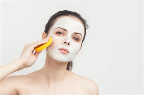 Premium Photo Perky Brunette With Cream Mask On The Face Naked