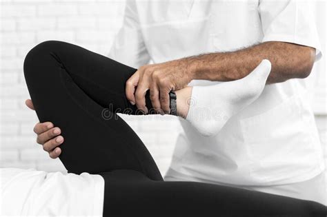 Male Physiotherapist Checking Woman S Leg Mobility High Quality Photo