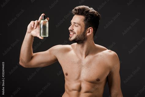 Sexy Smiling Naked Man Holding Bottle Of Cologne Isolated On Black Stock Photo Adobe Stock