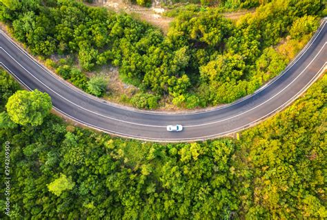 Aerial View Of Road With Car In Beautiful Forest At Sunset In Summer