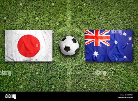 Japan vs. Australia flags on green soccer field Stock Photo - Alamy