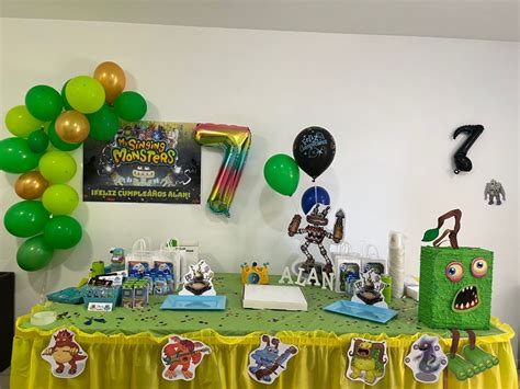 a party table with decorations and balloons on the wall in front of it ...