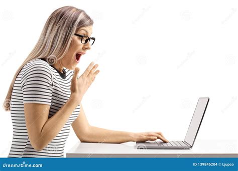 Surprised Young Woman Looking At A Laptop Computer Stock Photo Image