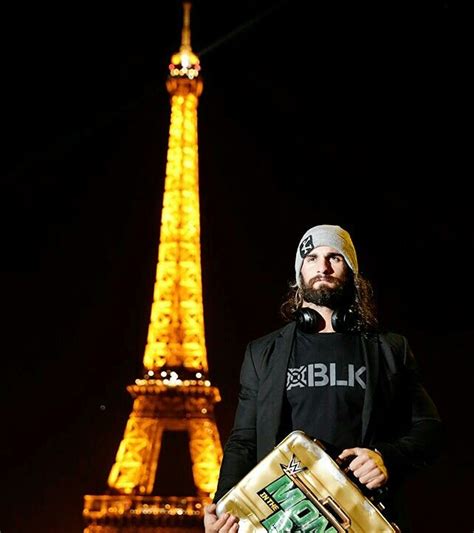 a man in front of the eiffel tower at night with a beer box