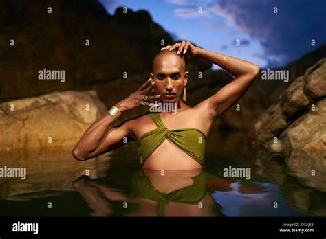 Gay Black Lgbtq Man Dives Out Of Water Inside Picturesque Natural Rocky Pond At Night