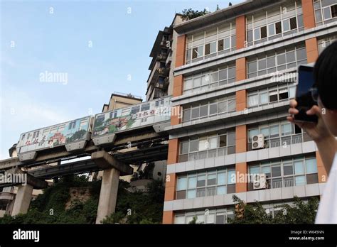 A Visitor Takes Photos Of A Monorail Train Of Chongqing Light Rail Line