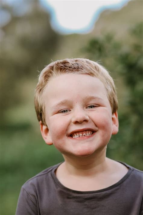 Vertical Shot Of A Cute Smiling Blonde Kid Stock Image Image Of Playful Person