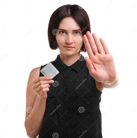 Aware Young Woman Showing A Condom Or Contraceptive Isolated On A White