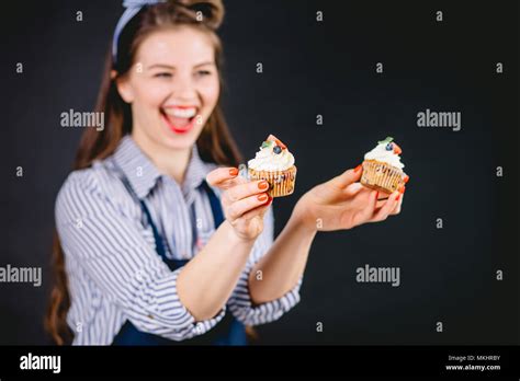 Beautiful Pastry Woman Holding Cupcake In Hands And Giving Different