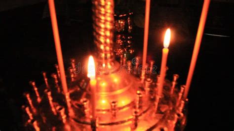 Burning Church Candles On Candlesticks With A Lamp In The Church Stock