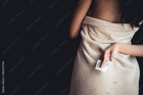Adult Sexy Woman Prepare A Condom For Use In Safe Sex To Protect From Disease Aids And