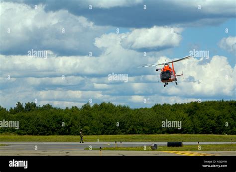 A US Coast Guard HH 65B SAR Helicopter demonstrates a search and rescue ...