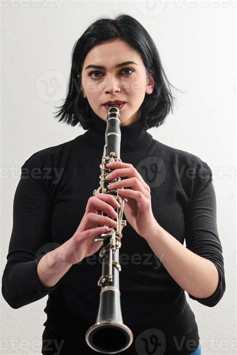 Graceful Brunette Musician Posing With Clarinet On White Background Stock Photo At Vecteezy