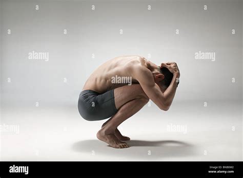 Mature Man Crouching Down Stock Photo Alamy