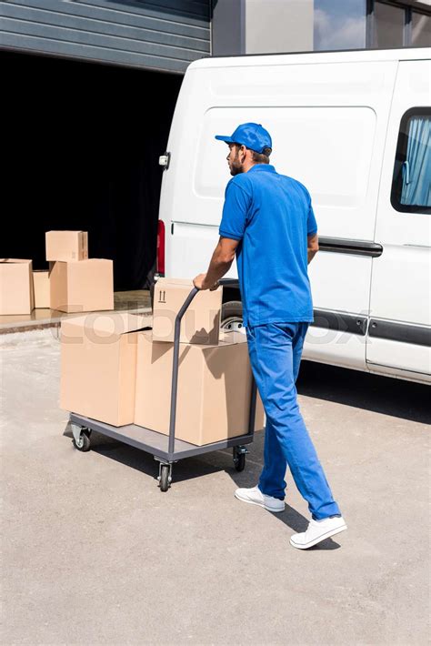 Delivery Man Driving Cart With Boxes Stock Image Colourbox