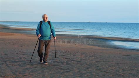 Mature Male Backpacker Scandinavian Walking Stick Sand Sea Sunset