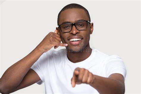 Smiling African American Man In Glasses Showing Call Me Gesture Stock