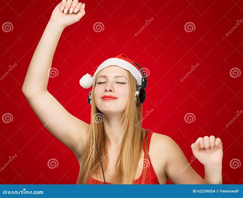 Young Woman In Santa Claus Hat And Headphones Take Pleasure From Stock