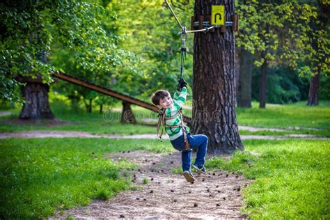 Smiling Boy Rides A Zip Line Happy Child On The Zip Line Stock Image