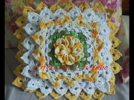 A Crocheted Flower Is Shown On The Side Of A Pillow With Yellow And