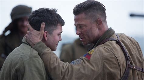 Fury Intense Moments Hd Wallpaper Featuring Brad Pitt And Logan Lerman