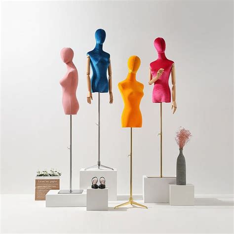 Three Different Colored Mannequins On Display In Front Of A White Wall