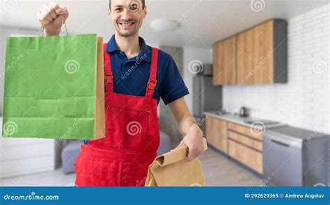 Box With Fast Food Being Carried By Delivery Man In Uniform For One Of