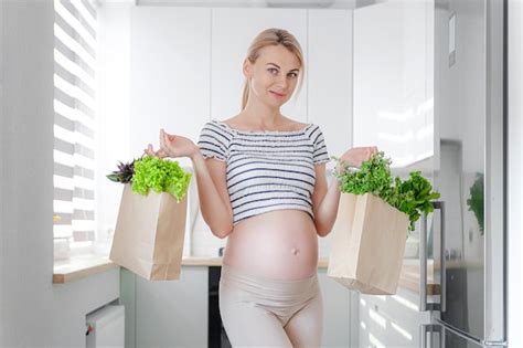 Premium Photo Pregnant Woman With Packages Of Fresh Herbs Green