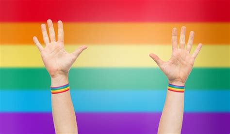 Premium Photo Hands With Gay Pride Rainbow Wristbands