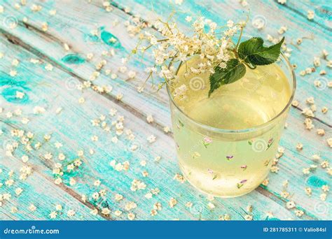 Dwarf Elderberry Juice Elderberry Syrup In A Glass Cup With Blossoms And Bunches Of