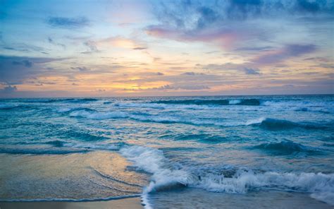 Download Aesthetic Ocean Waves During Sunset Wallpaper