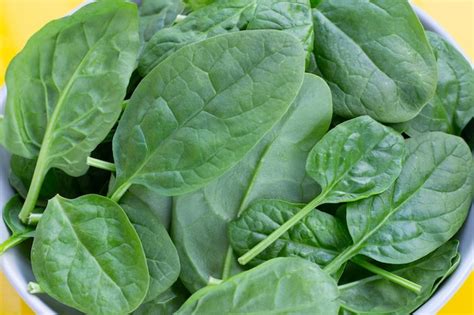 Premium Photo Spinach Leaves On Yellow Background