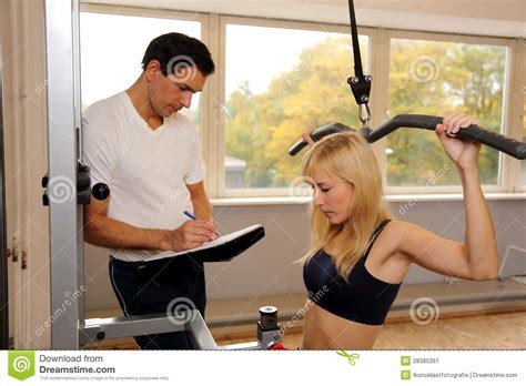 Attractive Blonde Woman And Her Trainer In A Gym Stock Image Image Of Energy Muscular