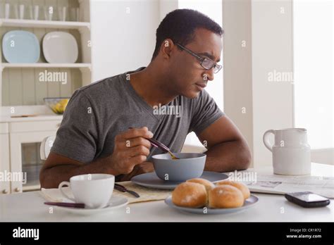 USA California Los Angeles Mature Man Eating Breakfast And Reading