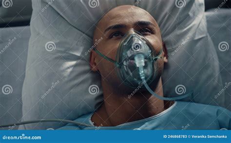 Portrait Patient Breathing Oxygen Mask Lying In Bed Hospital Emergency