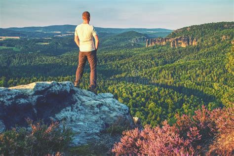 Man Walking On The Edge Of A Cliff At Summit Hrensko Range Stock Image